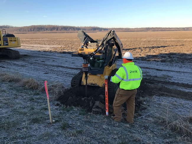 A SYTE worker on equipment for a relief well project.