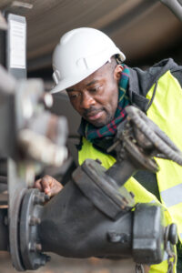 Close up of an African-American man checking a pipe.