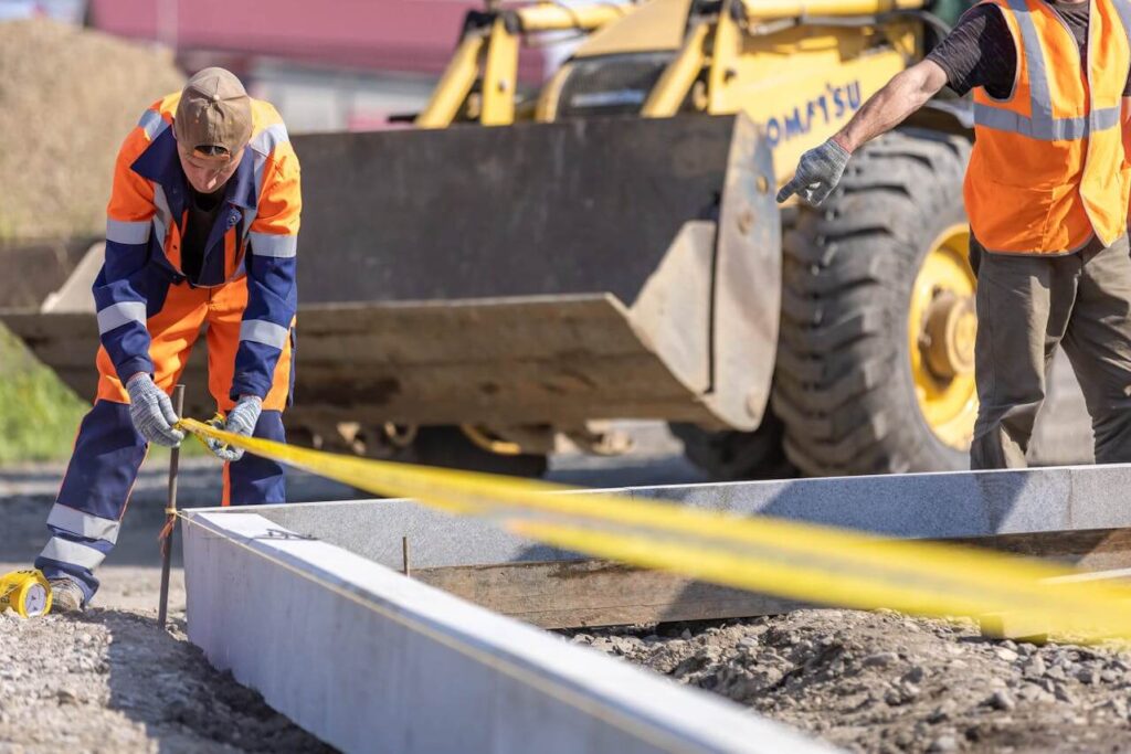 Construction workers marking off a boundary.
